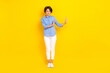 Full length photo of unsure moody lady wear blue shirt rising arms empty space isolated yellow color background
