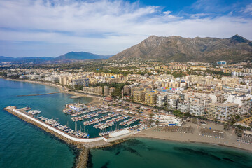 Wall Mural - The drone aerial view of the beach and downtown district of Marbella,  Spain.Marbella is a city and municipality in southern Spain, belonging to the province of Málaga.