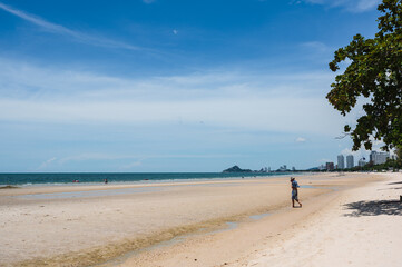 Wall Mural - Prachuap Khiri Khan.Thailand. 30.07.2022.:unacquainted people take a relax on huahin beach at Prachuap Khiri Khan thaailand.Hua Hin Beach is one of the most popular beaches in Thailand