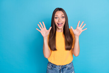 Wall Mural - Portrait of impressed positive lady raise opened arms palms cant believe empty space isolated on blue color background