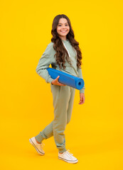 Poster - Girl teenager in tracksuit. Happy cute child in a yellow sports suit on a yellow background. Sportswear advertising concept.