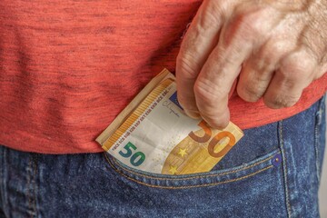 Wall Mural - man holding euro banknotes in his pocket