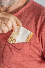 Wall Mural - man keeping euro banknotes in his shirt pocket