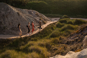 Wall Mural - Caucasian women with yoga mat standing at the summer path around the mountains