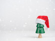 © Наталья Майшева - Christmas tree in a Santa hat on a light background. Christmas and New Year.