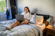 Young plus size woman using laptop while working or relaxing at home