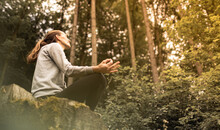 Woman In The Forest Meditating In Nature 