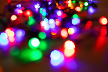 Wall Mural - Abstract background with colorful sparkling bokeh on a dark background. Holiday concept