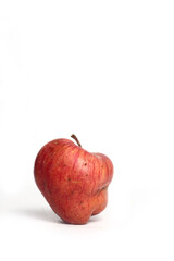 Concept of ugly food - red apple on white background