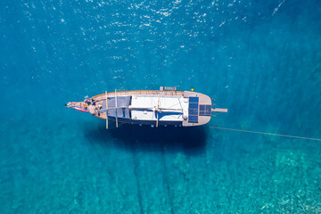 Wall Mural - Aerial view beautiful white yacht on clear blue sea in Turkey. Concept cruise travel by drone