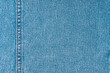Denim jeans texture background. Texture of blue colored cotton fabric with decorative seam. Stiched texture jean background. Fiber and fabric structurel. Wallpaper, banner, backdrop, header