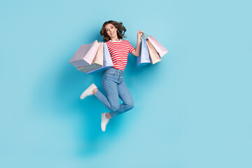 Poster - Full length photo of cute adorable lady wear striped t-shirt jumping high rising bargains isolated blue color background