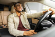 © Home-stock - Portrait of happy african american man driving car with beige interior