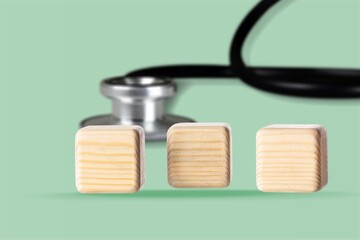 Wall Mural - wooden cubes blocks and medical stethoscope