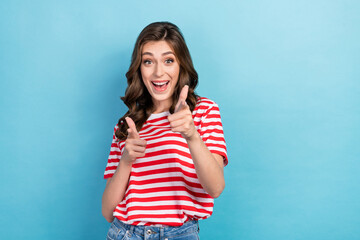 Poster - Photo of cool excited girl dressed red t-shirt pointing finger you empty space isolated blue color background