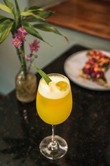 Sticker - Yellow citrus alcoholic drink on a black marble table