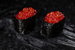 sushi red caviar on black background