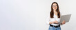 Leinwandbild Motiv Portrait of young office woman, entrepreneur answer clients on laptop, working with computer with happy face, standing over white background
