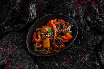 Sticker - Wok pepper beef in a plate on a black background