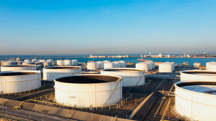Wall Mural - Aerial top view of White oil tank storage chemical petroleum petrochemical refinery product at oil terminal. Oil terminal storage tank in deep seaport for the international order concept. 