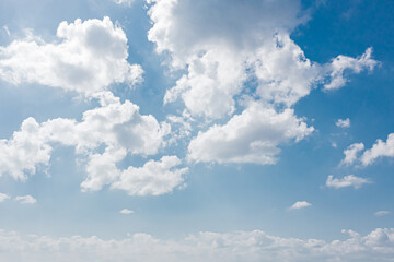Wall Mural - A clear sky with a three-dimensional effect due to the harmony between the low clouds and the high clouds