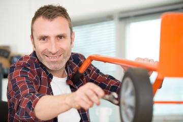 man assembling a sack truck