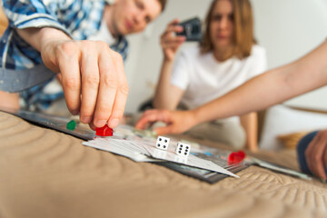 Friends play board game.Focus on dice