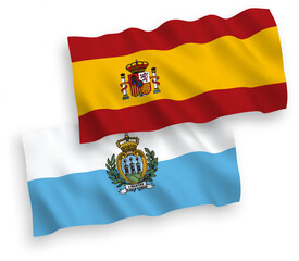 National vector fabric wave flags of San Marino and Spain isolated on white background. 1 to 2 proportion.