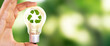 Close up photo of lightbulb with recycle icon with nature background as a symbol of reduce, reuse and recycle of resources. Concept of protect nature, environment, ecosystem and world.