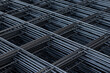 Group of new deformed bar or reinforced concrete construction steel net piles on outdoor ground. Selective focus and blurred for copy space.