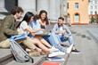 © yurolaitsalbert - group of students with a laptop sitting on the steps.