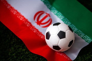 Wall Mural - Iran national football team. National Flag on green grass and soccer ball. Football wallpaper for Championship and Tournament in 2022. World international match.