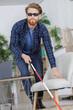 © auremar - visually impaired man at home feeling way with a cane