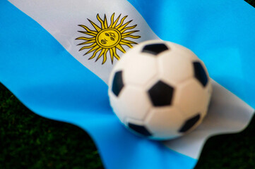 Wall Mural - Argentina national football team. National Flag on green grass and soccer ball. Football wallpaper for Championship and Tournament in 2022. World international match.