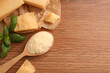 Delicious parmesan cheese on wooden table, flat lay. Space for text