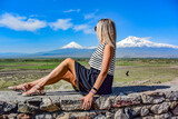 Fototapeta Tęcza - Young girl on the background of a beautiful view of mount Ararat in the afternoon. Armenia2019