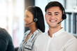 © Clayton D/peopleimages.com - Man, consultant and call center with smile for customer service, telemarketing or advice at the office. Happy male employee smiling with headset in contact us, consulting or desktop support agency