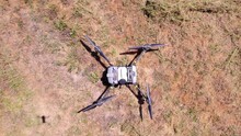 Aerial Top Down View Of High Tech Drone Specialized In Agriculture Data Perched In Field Ground