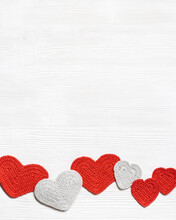 Valentines Day Background, Knit Hearts Valentine, Handmade Red Crochet Heart On White Wood Table, Handmade Gift For Romance Holiday, Symbol Of Love. Festive Card With Copy Space. Top View