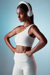 © Talia M/peopleimages.com - Fitness, studio and woman streaming music ready to start training, workout and body exercise in India, Mumbai. Focus, blue background and healthy girl athlete listening to radio or mindset podcast