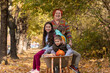 © oksix - Mother have fun time with kids, use garden wheelbarrow with pumpkins