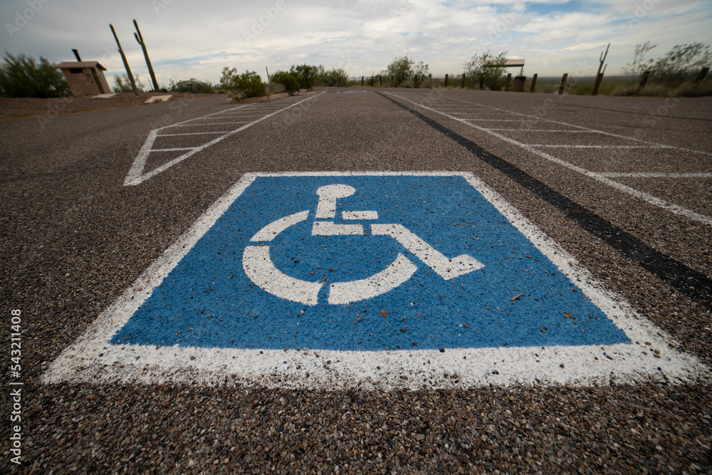 A handicap parking space symbol in an empty parking lot