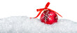 Red christmas bauble in the snow with copy space