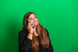 © Artframe  - Young woman, wearing black, holding a smartphone, on  Green Background