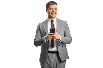 Wall Mural - Young professional man in a gray suit using a smartphone and smiling