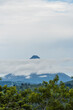© STOCKEROcr - Paisaje de un día nublado donde se nota el Volcán arenal mostrando su cono en medio de un cúmulo de nubes
