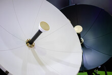 White Satellite Dish Antenna, VSAT Parabolic Receiver Using To Receive Or Transmit Information At Telecommunication Exhibition - Close Up. Broadcasting, Communication, Technology Concept