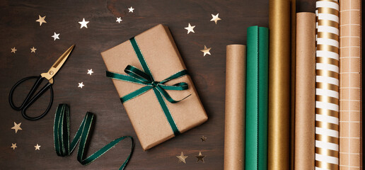 Christmas background with gift boxes and rolls of wrapping paper