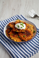 Wall Mural - Homemade Fried Cheddar Corn Fritters on a Plate, side view.