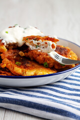 Wall Mural - Homemade Fried Cheddar Corn Fritters on a Plate, side view.